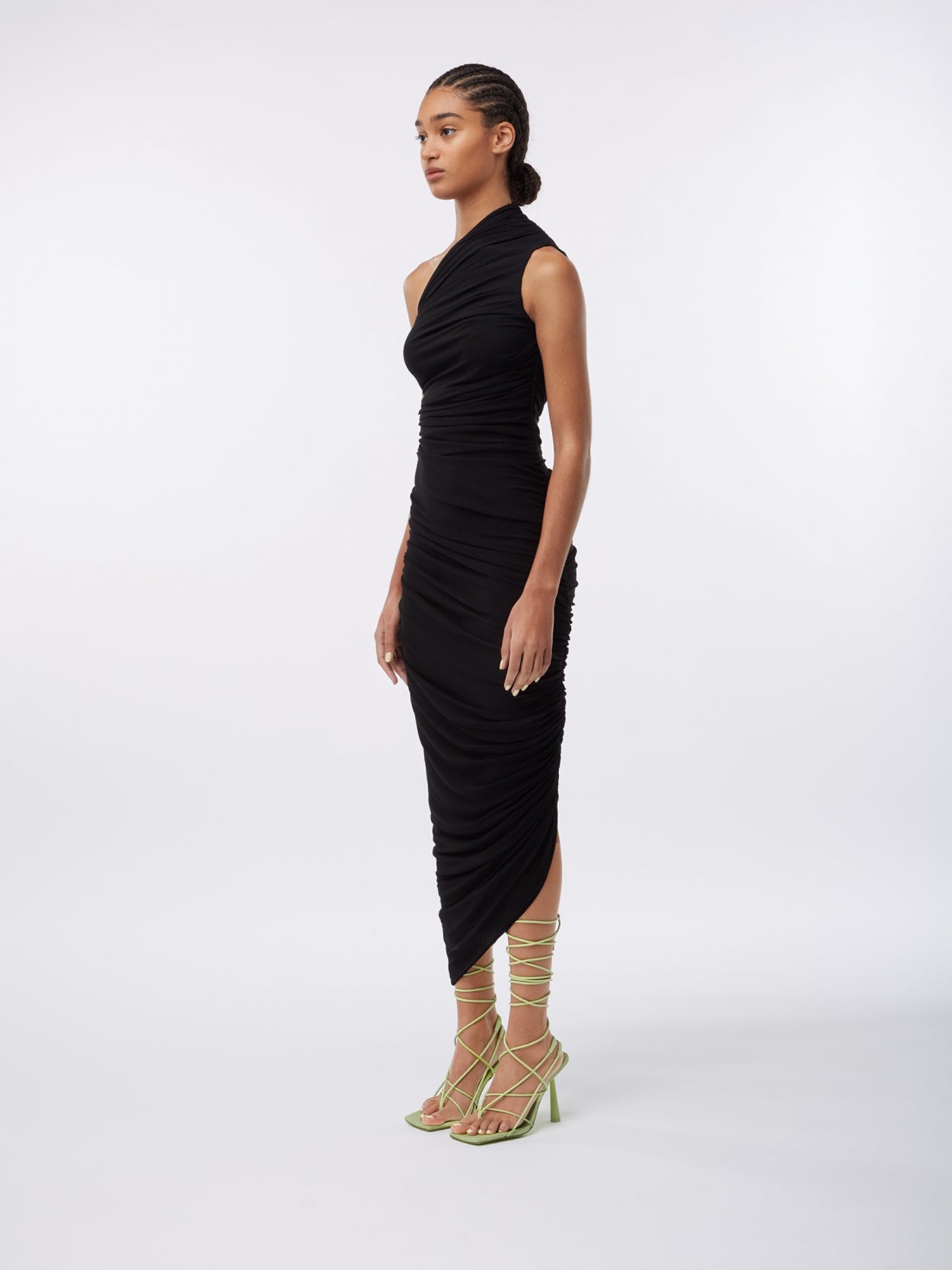 model wearing a one shoulder black draped dress